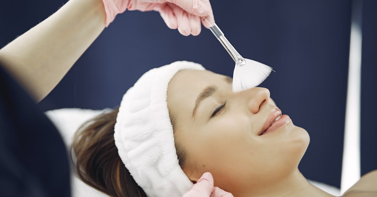 Woman enjoying a relaxing facial treatment at a spa, highlighting skincare and relaxation.